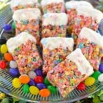 White Chocolate Dipped Krispy Treats with colorful cereal and sprinkles on clear glass plate with candy garnish