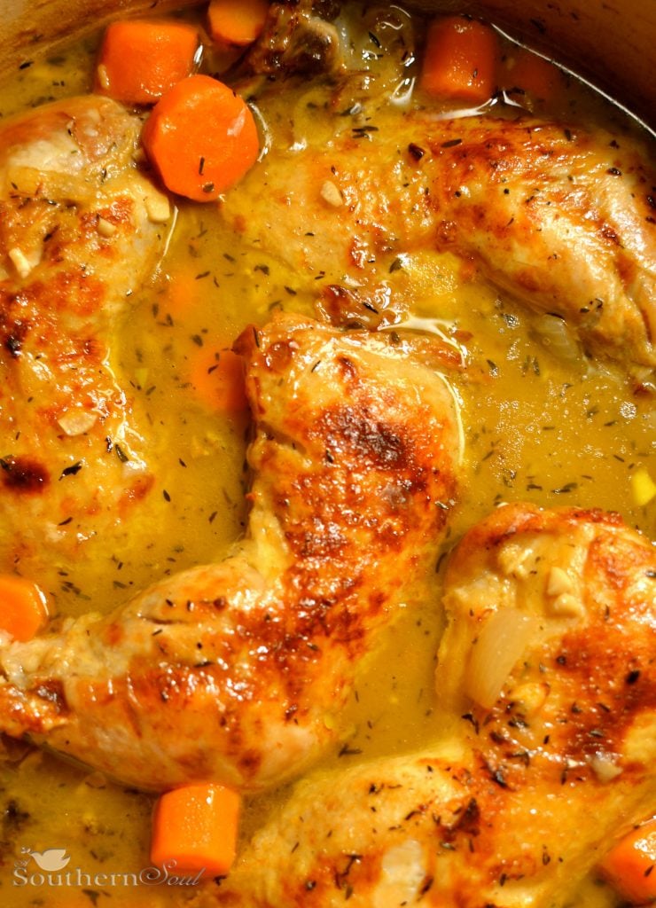 Braised chicken leg quarters being braised in a beautiful, flavorful sauce.