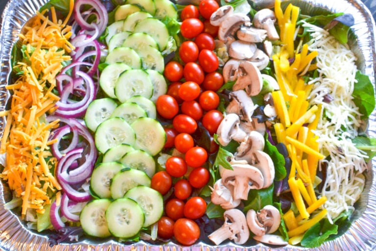 Salad for a crowd with tomatoes, cucumbers, onions, mushrooms and cheese with a homemade vinaigrette is a hit at any gathering or party.