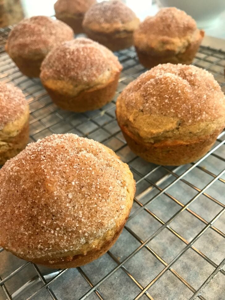 Freshly baked Whole Wheat Applesauce Muffins with cinnamon sugar coating cooling on a wire rack