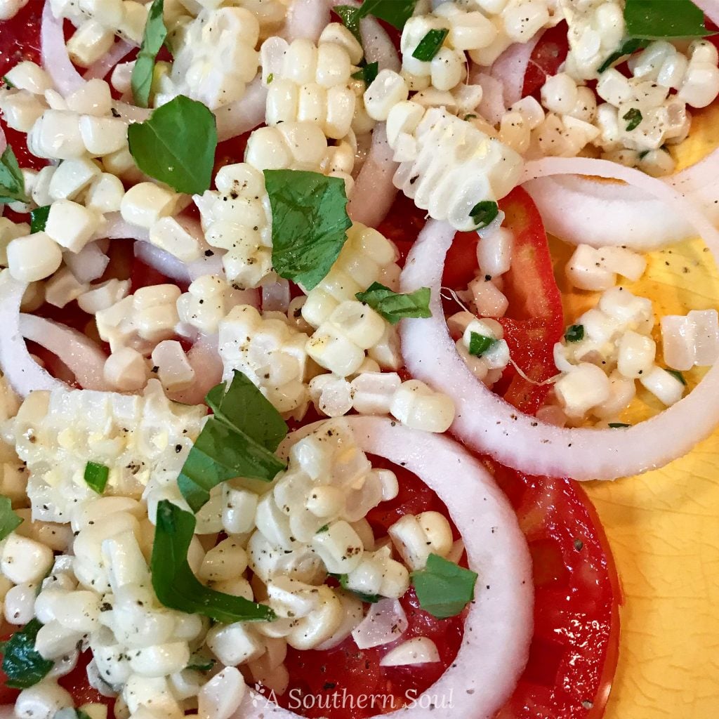 summer salad with tomatoes, onions, corn and herbs