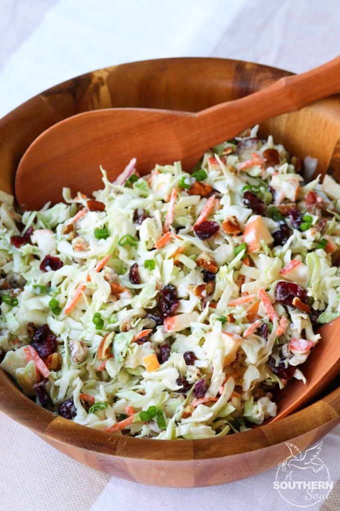 Cranberry Pecan Slaw for Thanksgiving served in a wooden bowl.