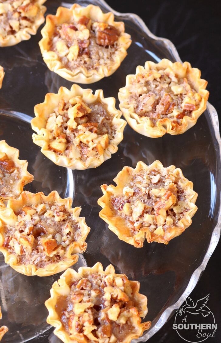Pecan Pie Tart Bites are a fun little treat loaded with all the flavor of a regular slice of pie! Easy to make with the help of store bought phyllo cups, this dessert comes together in less than 15 minutes.