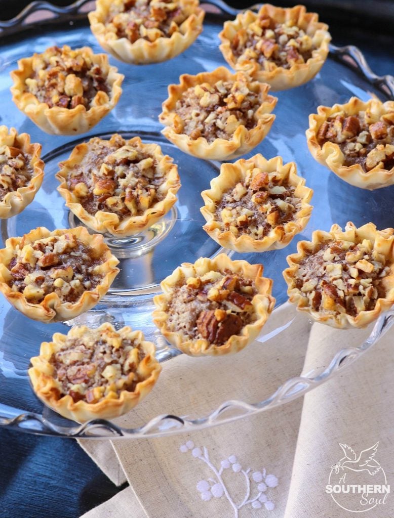 Pecan Pie Tart Bites are a fun little treat loaded with all the flavor of a regular slice of pie! Easy to make with the help of store bought phyllo cups, this dessert comes together in less than 15 minutes.