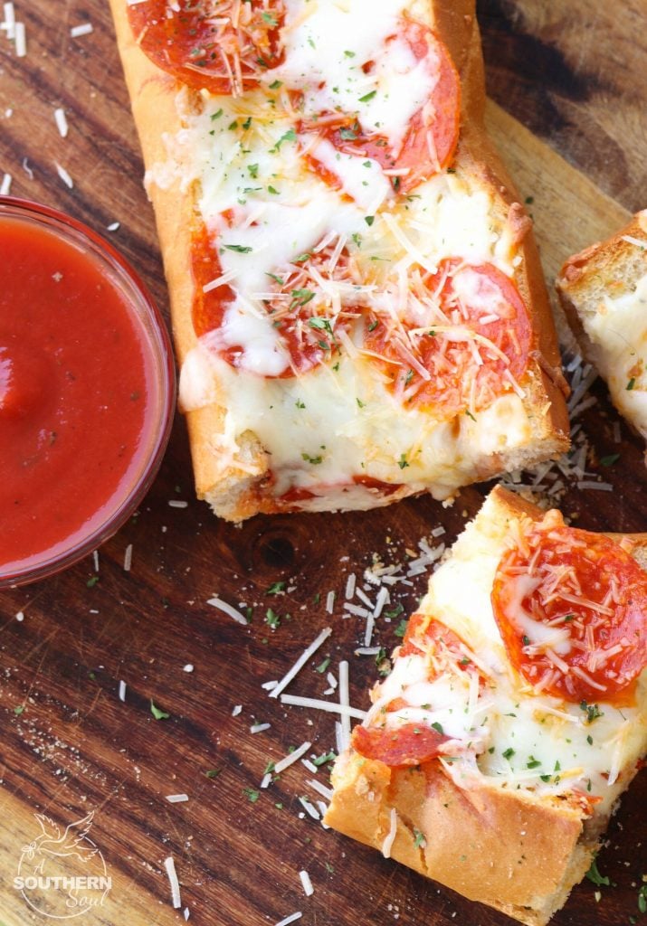 Meat Lovers Stuffed French Bread Pizza is easy to make and loaded with flavor. Hamburger and pepperoni along with two kinds of gooey cheese make this a recipe perfect for a weeknight meal or for game day!