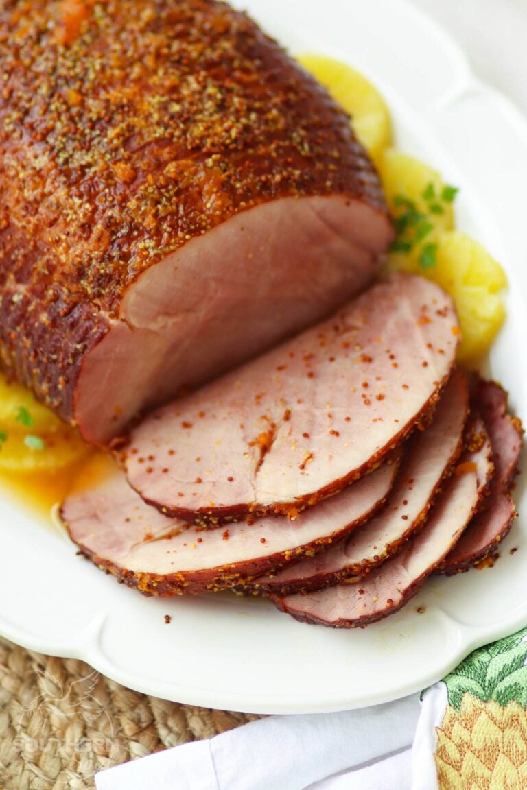 Crock Pot Sweet & Savory Ham is cooked in the slow cooker with pineapple juice, apricot preserves and whole gain mustard. It's the perfect dish to serve on any holiday and great for covered dish supper, picnics and makes wonderful sandwiches!