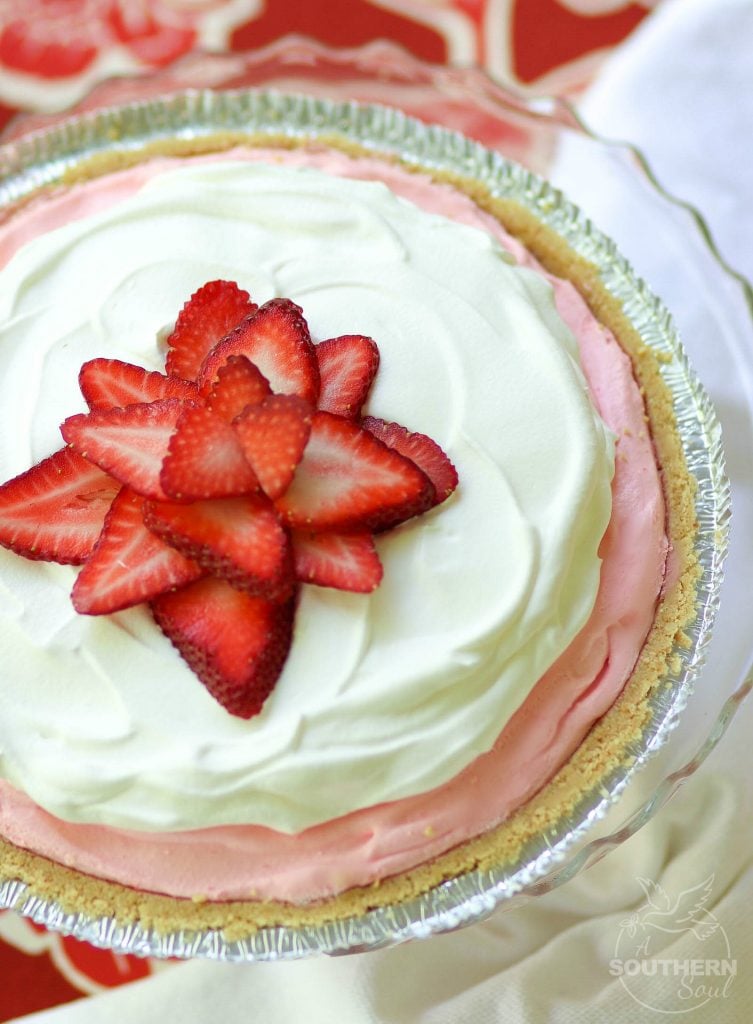 Strawberry Cream Pie made with fresh whipped cream and strawberry jello is an easy to make dessert that is cool and delicious. It's perfect for the holidays, potluck or covered dish suppers or a weeknight meal.