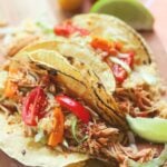Shredded chicken cooked low and slow in the crock pot is flavored with taco seasoning and salsa. It's an easy to make recipe that great for tacos, nachos, burrito bowls and salads.