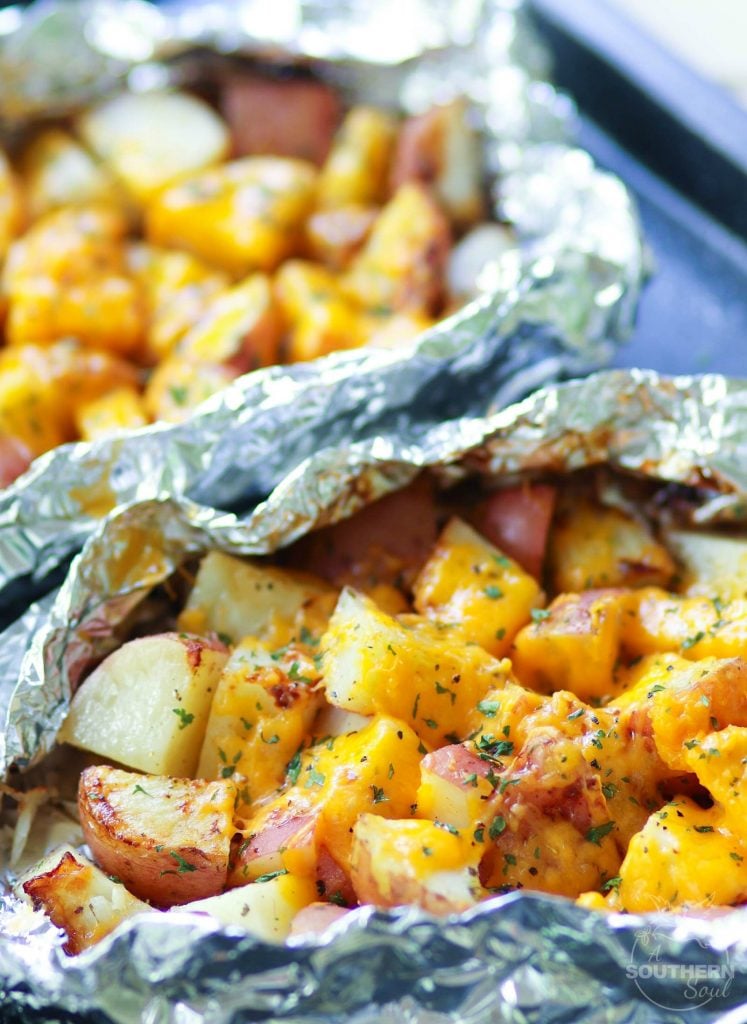 Red potatoes flavored with ranch seasoning then cooked on the grill in foil packets are loaded with cheese for a side dish that is perfect for any cookout or BBQ!