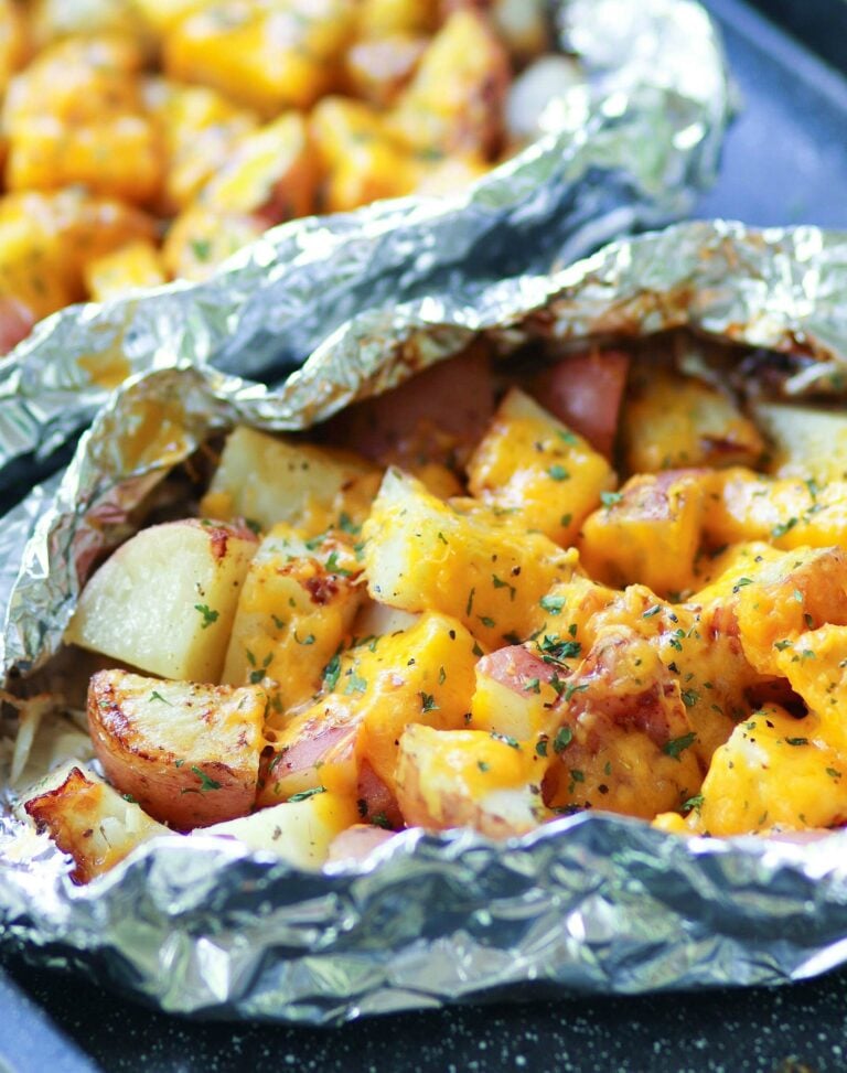 Red potatoes flavored with ranch seasoning then cooked on the grill in foil packets are loaded with cheese for a side dish that is perfect for any cookout or BBQ!