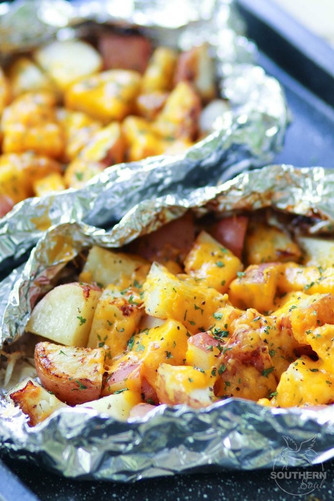 Red potatoes flavored with ranch seasoning then cooked on the grill in foil packets are loaded with cheese for a side dish that is perfect for any cookout or BBQ!