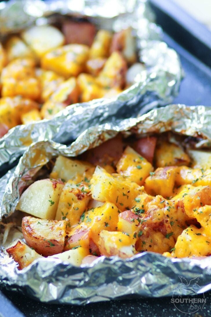 Red potatoes flavored with ranch seasoning then cooked on the grill in foil packets are loaded with cheese for a side dish that is perfect for any cookout or BBQ!