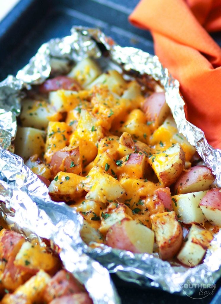 Red potatoes flavored with ranch seasoning then cooked on the grill in foil packets are loaded with cheese for a side dish that is perfect for any cookout or BBQ!