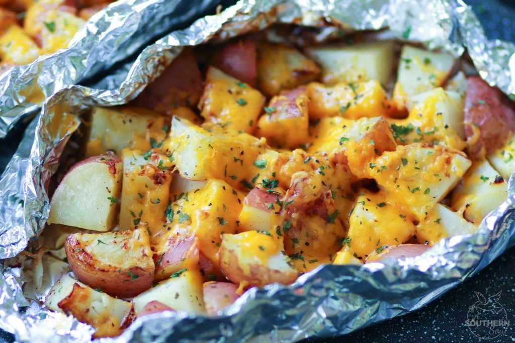 Red potatoes flavored with ranch seasoning then cooked on the grill in foil packets are loaded with cheese for a side dish that is perfect for any cookout or BBQ!