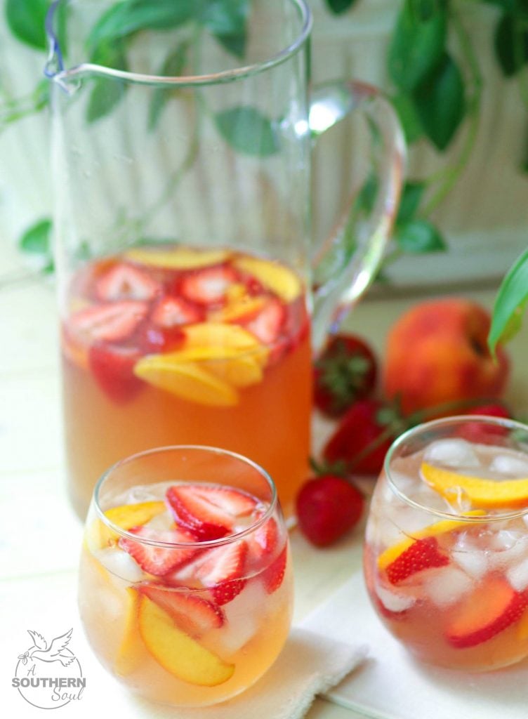 Rose sangria flavored with peach schnapps, peach juice with fresh fruit is a cool drink that's excellent for summertime!,