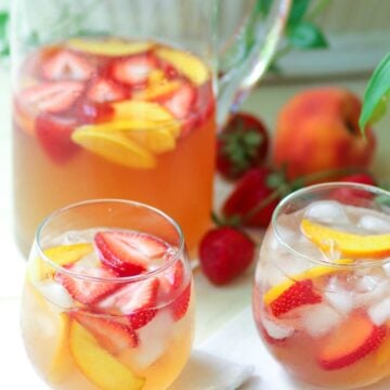 Rose sangria flavored with peach schnapps, peach juice with fresh fruit is a cool drink that's excellent for summertime!,