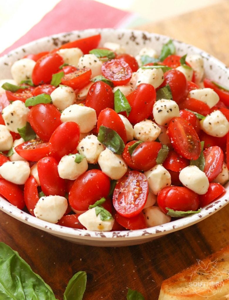 Garden fresh tomatoes and herbs tossed with mozzarella, along with basil in a two ingredient dressing of olive oil and balsamic vinegar might just be the most simple, most delicious salad ever!