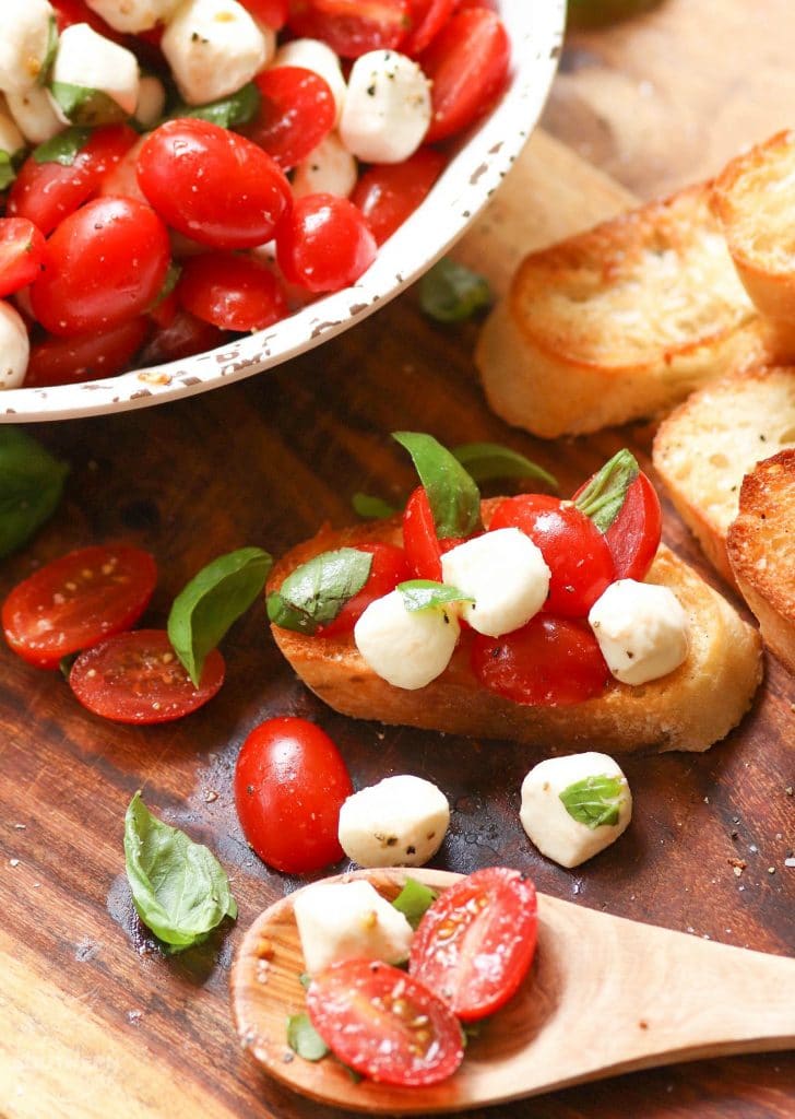 Garden fresh tomatoes and herbs tossed with mozzarella, along with basil in a two ingredient dressing of olive oil and balsamic vinegar might just be the most simple, most delicious salad ever!