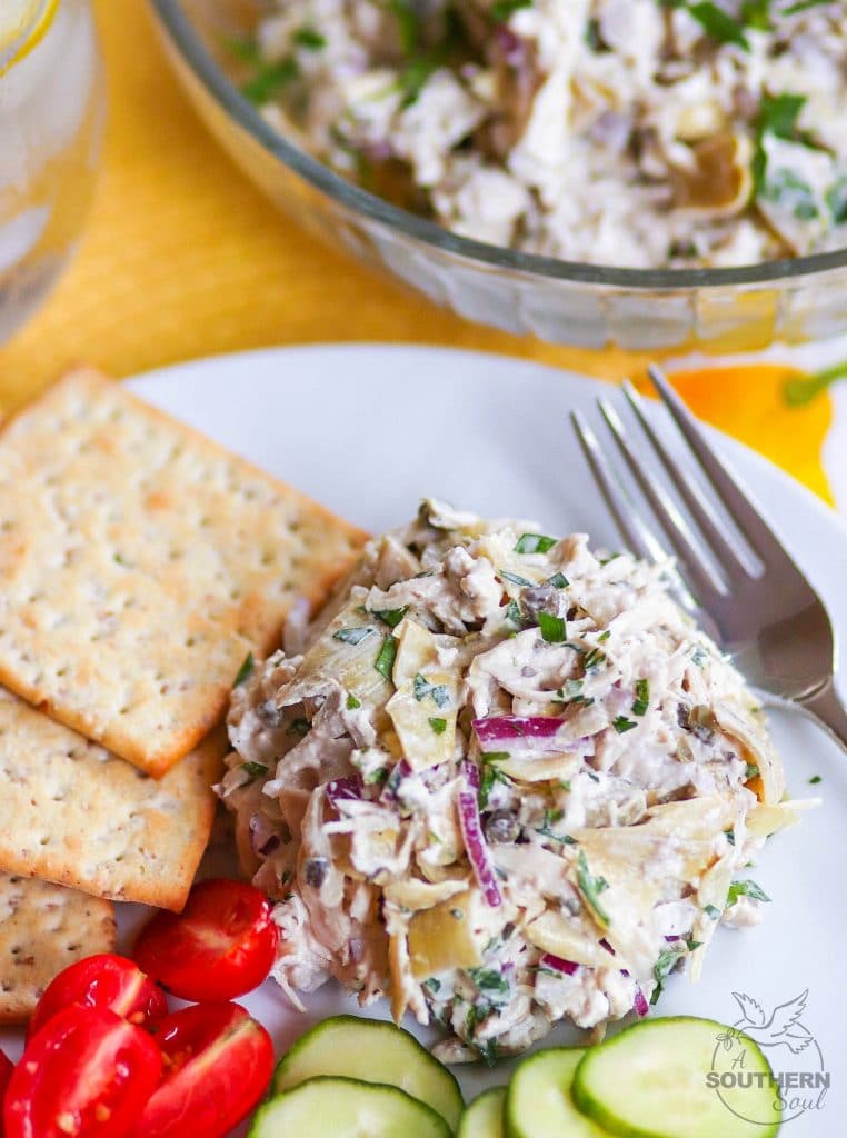 Artichoke Chicken Salad made with shredded white meat chicken, artichokes, capers and red onion tossed in a creamy, light, fresh dressing is a great new twist on a classic recipe!