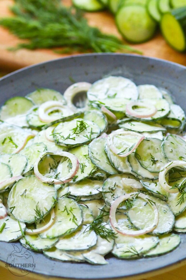 Creamy Cucumber Salad is a simple side dish that's full of fresh flavor. Make with cucumbers and onions in a dressing of sour cream, vinegar, sugar, dill, salt, pepper and garlic it's a cool creamy salad to enjoy any time of the year!