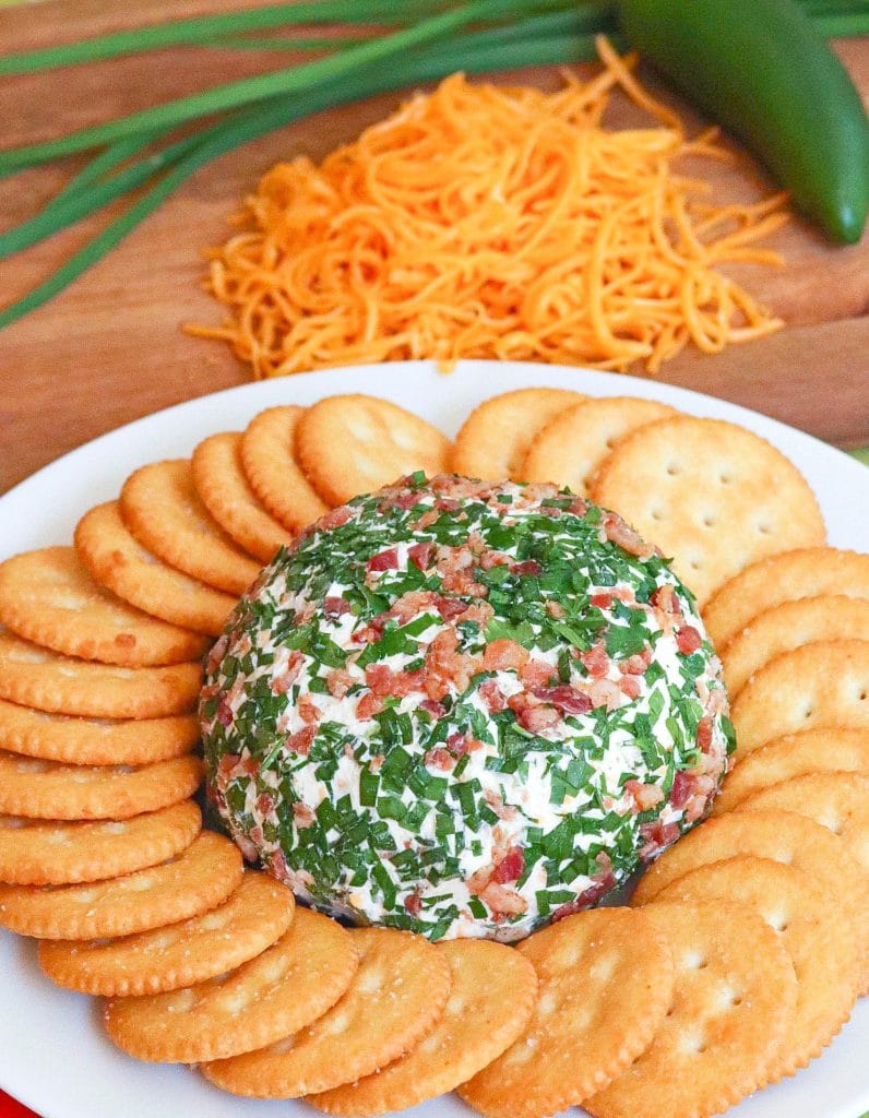 Jalapeno Popper Cheese Ball made with cream cheese, jalapenos, cheddar cheese, ranch seasoning, bacon and chives is an easy to make crowd please appetizer!
