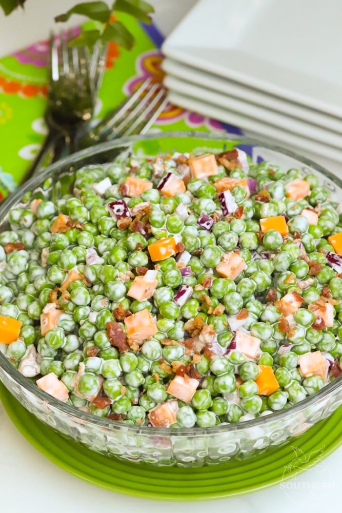 Classic Pea Salad made with thawed peas, cheese, bacon and red onion, then tossed in a creamy, sweet & tangy dressing is a classic side dish that perfect to serve any time of the year!