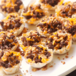 Bacon Cheeseburger Bites made with ground beef, bacon and cheese stuffed phyllo cups are great for parties, tailgating and the perfect bite size snack!