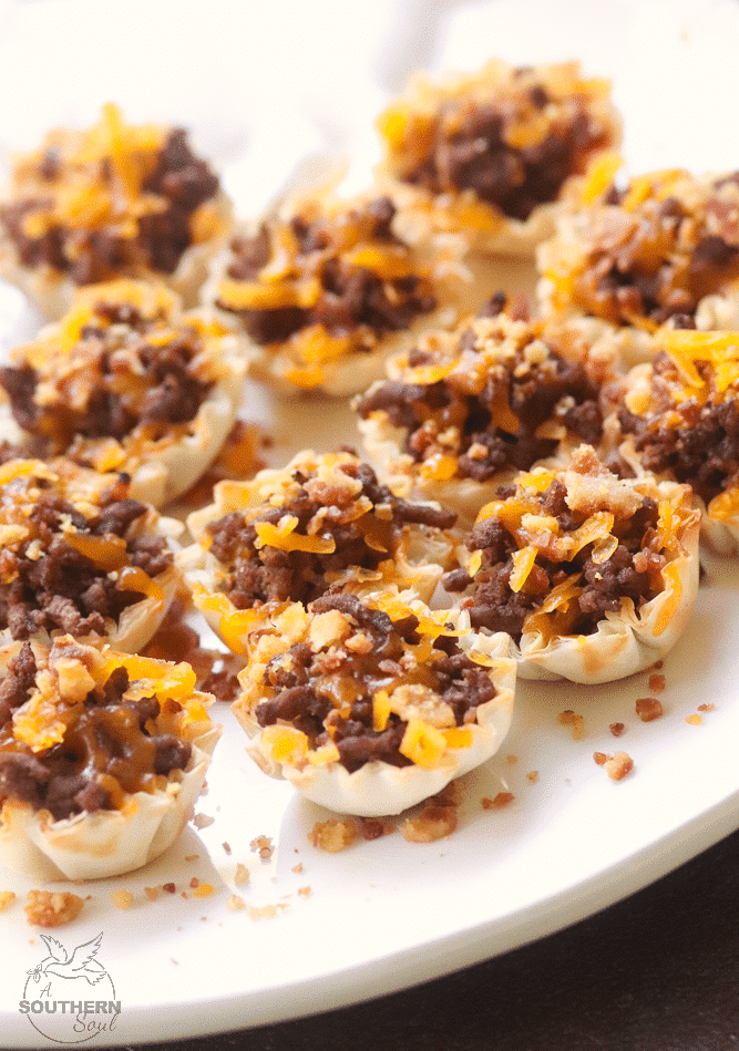 Bacon Cheeseburger Bites made with ground beef, bacon and cheese stuffed phyllo cups are great for parties, tailgating and the perfect bite size snack!