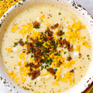 Rich, creamy potato soup made in the crockpot is a fall favorite dish that is warm and comforting! Top it with cheese, bacon and chives just like a loaded baked potato.