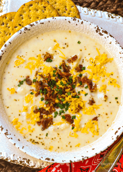 Rich, creamy potato soup made in the crockpot is a fall favorite dish that is warm and comforting! Top it with cheese, bacon and chives just like a loaded baked potato.