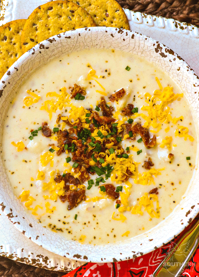 Rich, creamy potato soup made in the crockpot is a fall favorite dish that is warm and comforting! Top it with cheese, bacon and chives just like a loaded baked potato.