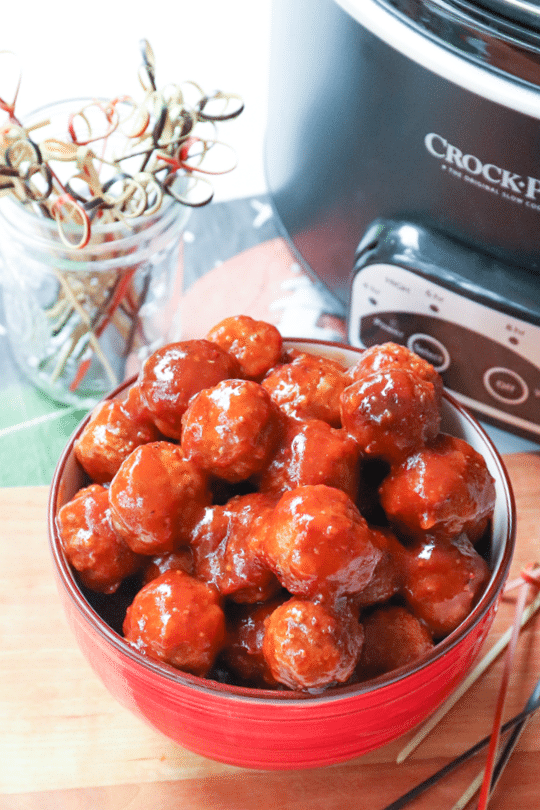 A heaping bowl of hearty meatballs, cooked low and slow in the Crock Pot in a sauce made with BBQ sauce, apricot preserves and whole grain mustard.
