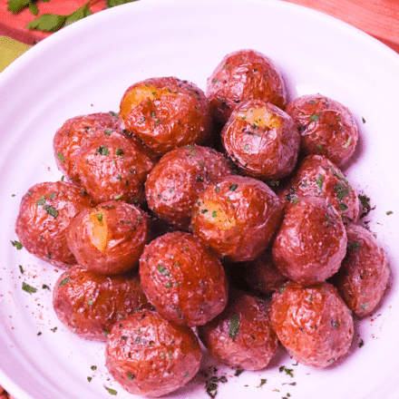 Air Fryer Baby Potatoes are tossed in butter, salt, pepper and parsley for a side dish that's irresistible. Crispy on the outside and soft on the inside these easy to make potatoes are great served for breakfast, lunch or dinner!