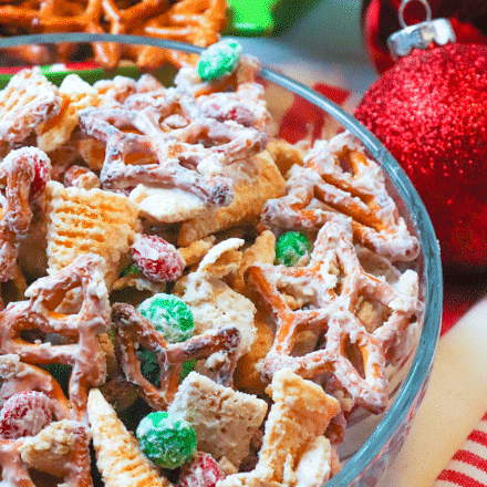 Christmas Snack Mix is a festive blend of rice cereal, pretzels, corn snacks and M&M all coated is a sweet vanilla bark. This easy to make treat is sure to make Christmas extra sweet.
