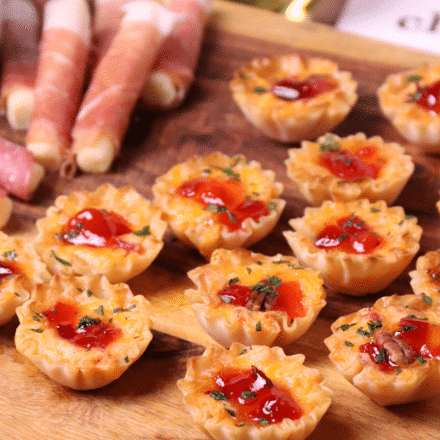 Crispy Phyllo cups filled with pimento cheese then topped with sweet, slightly spicy red pepper jelly makes for delicious appetizer for the holidays, game day or whenever you're entertaining!