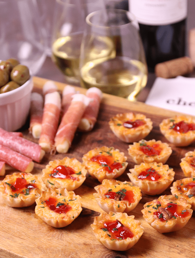 Crispy Phyllo cups filled with pimento cheese then topped with sweet, slightly spicy red pepper jelly makes for delicious appetizer for the holidays, game day or whenever you're entertaining!