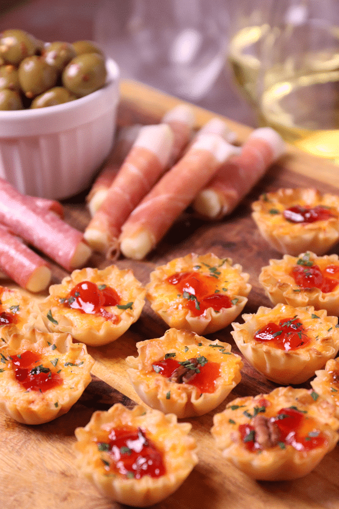 Crispy Phyllo cups filled with pimento cheese then topped with sweet, slightly spicy red pepper jelly makes for delicious appetizer for the holidays, game day or whenever you're entertaining!