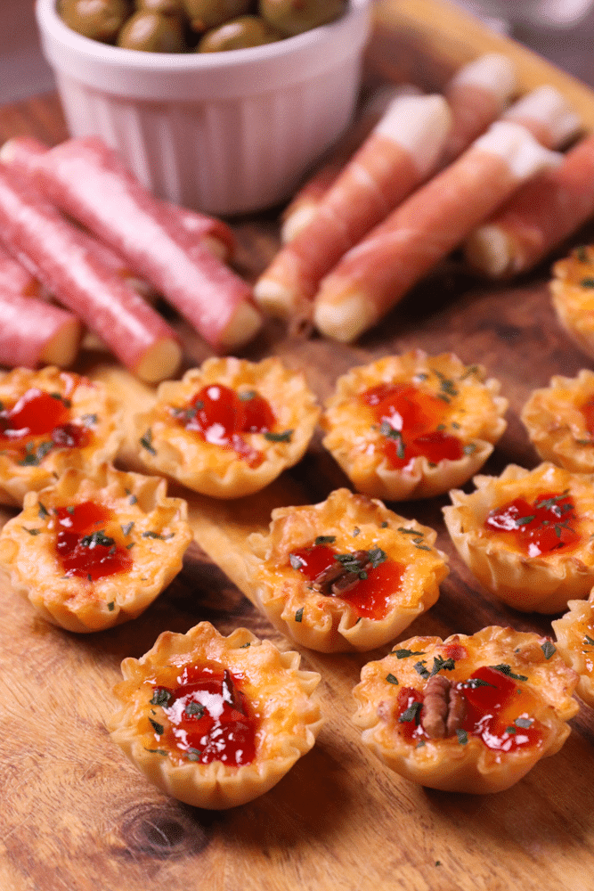 Crispy Phyllo cups filled with pimento cheese then topped with sweet, slightly spicy red pepper jelly makes for delicious appetizer for the holidays, game day or whenever you're entertaining!