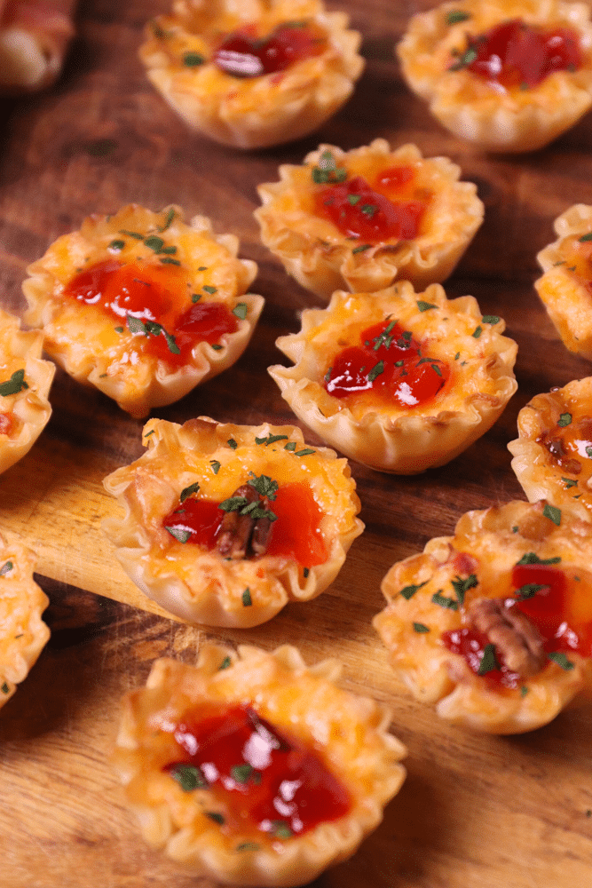Crispy Phyllo cups filled with pimento cheese then topped with sweet, slightly spicy red pepper jelly makes for delicious appetizer for the holidays, game day or whenever you're entertaining!