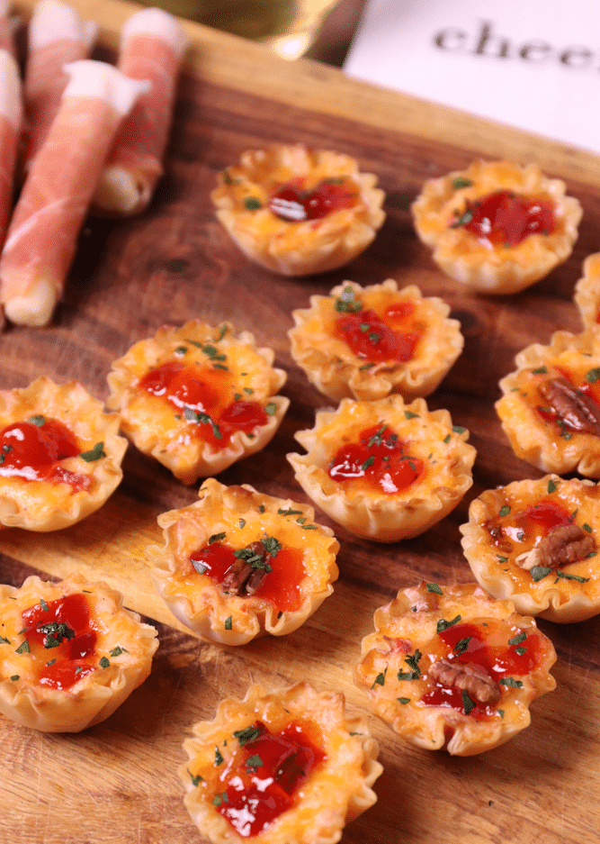 Crispy Phyllo cups filled with pimento cheese then topped with sweet, slightly spicy red pepper jelly makes for delicious appetizer for the holidays, game day or whenever you're entertaining!
