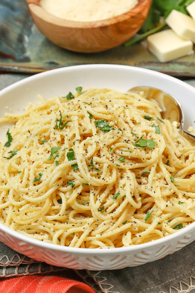 Instant Pot Garlic Parmesan Noodles is comfort food made in 20 minutes. Made with butter, garlic, chicken stock, pasta, Parmesan salt and pepper, this easy recipe is perfect for a week night meal when you've got to get supper on the table in a hurry.