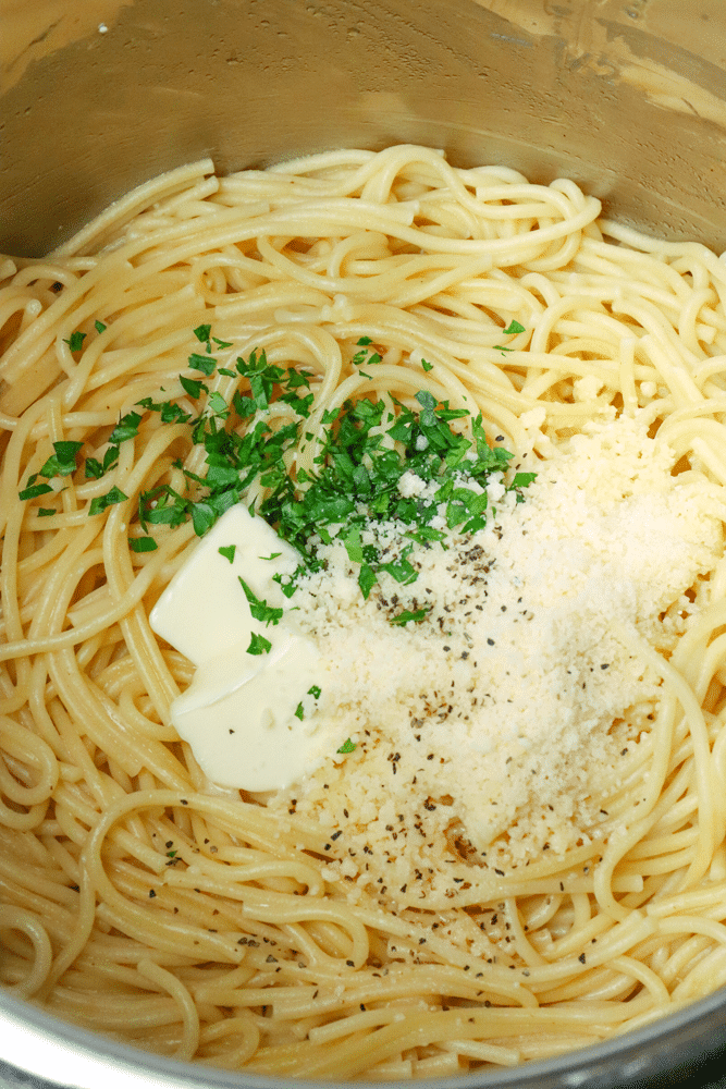 Instant Pot Garlic Parmesan Noodles is comfort food made in 20 minutes. Made with butter, garlic, chicken stock, pasta, Parmesan salt and pepper, this easy recipe is perfect for a week night meal when you've got to get supper on the table in a hurry.