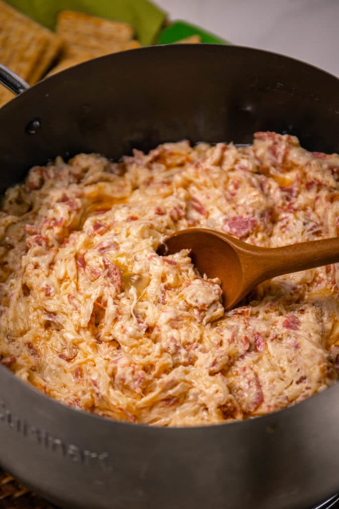 Crock Pot Reuben Dip is so easy to make with just a few ingredients. Make with corned beef, sauerkraut, thousand island dressing and swiss cheese just like the famous, classic sandwich!