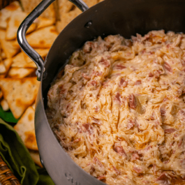 Crock Pot Reuben Dip is so easy to make with just a few ingredients. Make with corned beef, sauerkraut, thousand island dressing and swiss cheese just like the famous, classic sandwich!