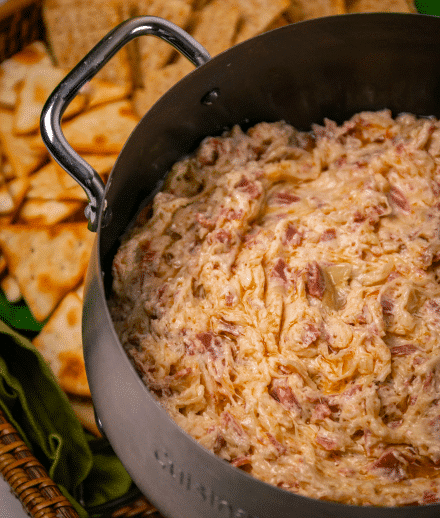 Crock Pot Reuben Dip is so easy to make with just a few ingredients. Make with corned beef, sauerkraut, thousand island dressing and swiss cheese just like the famous, classic sandwich!