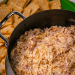 Crock Pot Reuben Dip is so easy to make with just a few ingredients. Make with corned beef, sauerkraut, thousand island dressing and swiss cheese just like the famous, classic sandwich!