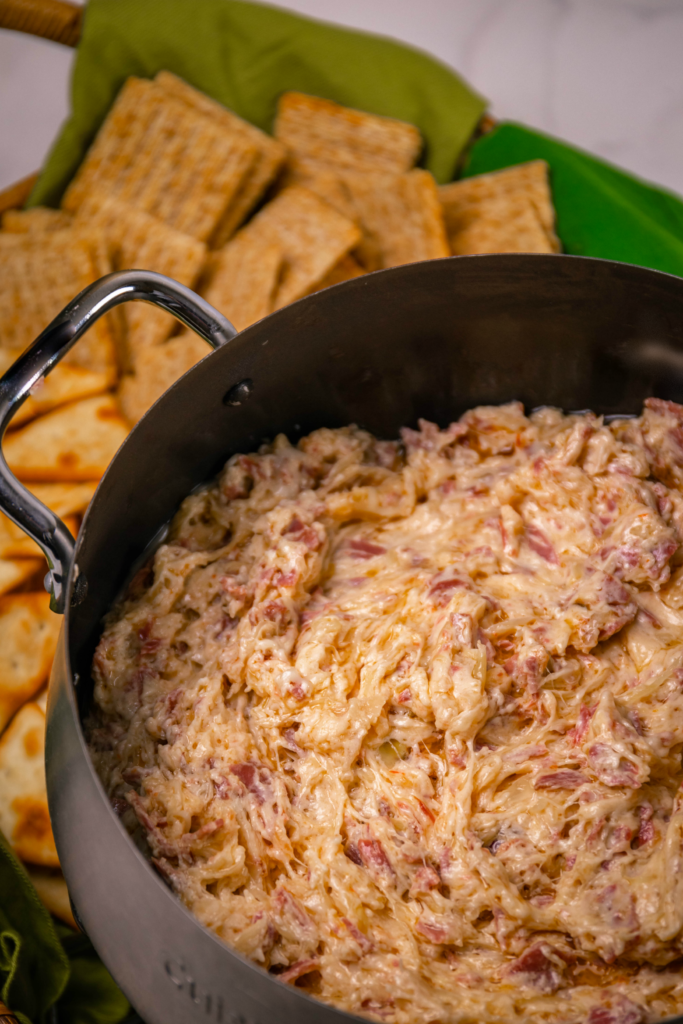 Crock Pot Reuben Dip is so easy to make with just a few ingredients. Make with corned beef, sauerkraut, thousand island dressing and swiss cheese just like the famous, classic sandwich!