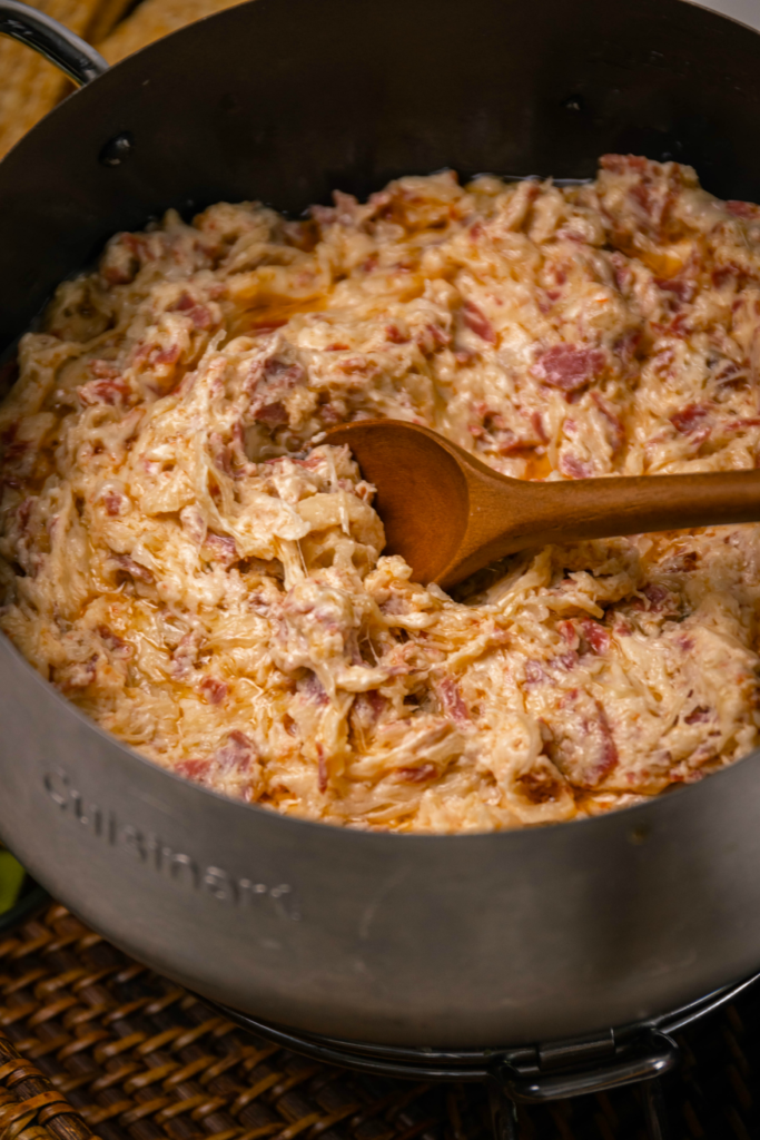Crock Pot Reuben Dip is so easy to make with just a few ingredients. Make with corned beef, sauerkraut, thousand island dressing and swiss cheese just like the famous, classic sandwich!