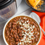 Instant Pot Pinto Beans are so easy to make! Seasoned with ham, onion and garlic then cooked in vegetable stock, this no-soak recipe is great as a main or side dish.