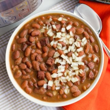 Instant Pot Pinto Beans are so easy to make! Seasoned with ham, onion and garlic then cooked in vegetable stock, this no-soak recipe is great as a main or side dish.